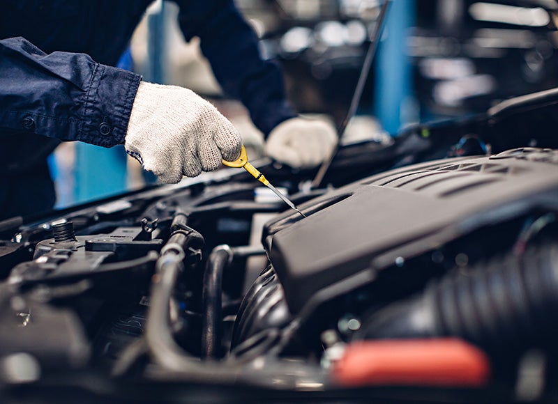 a service technician changing the oil in a vehicle